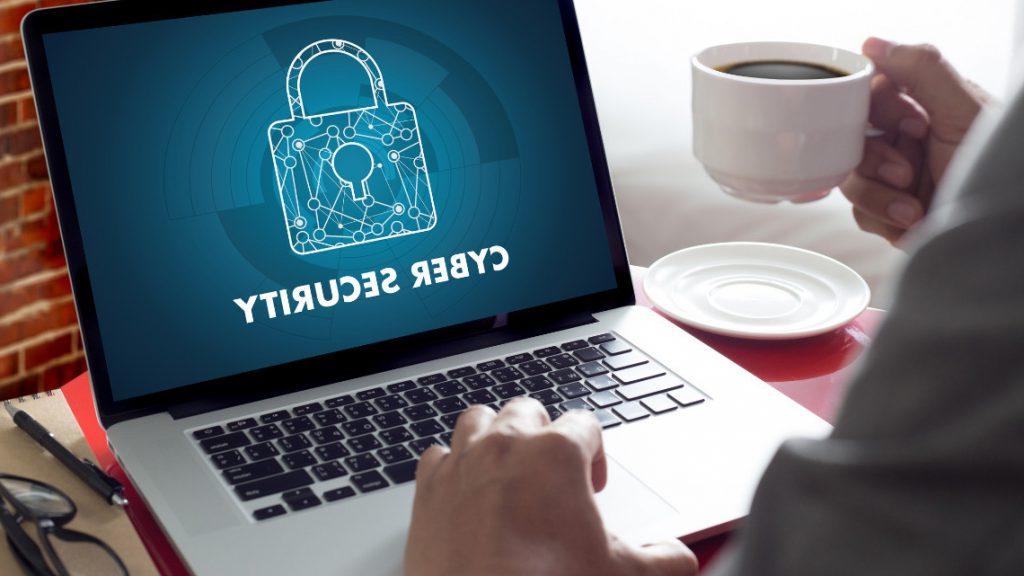 employee at a laptop displaying a cybersecurity related image